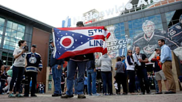 COLUMBUS, OH - APRIL 18: A Columbus Blue Jackets fan holds an Ohio flag with the fan motto '5th Line' up outside of Nationwide Arena prior to going in for Game Four of the Eastern Conference First Round during the 2017 NHL Stanley Cup Playoffs against the Pittsburgh Penguins on April 18, 2017 at Nationwide Arena in Columbus, Ohio. (Photo by Kirk Irwin/Getty Images)