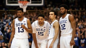 Jan 3, 2015; Durham, NC, USA; Duke Blue Devils guard Matt Jones (13) and center Jahlil Okafor (15) and guard Tyus Jones (5) and forward Justise Winslow (12) watch as teammate guard Quinn Cook (not pictured) shoots a technical foul shot in their game against the Boston College Eagles at Cameron Indoor Stadium. Mandatory Credit: Mark Dolejs-USA TODAY Sports