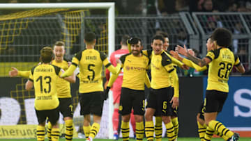 Dortmund's German forward Marco Reus and his teammates celebrate after scoring during the German first division Bundesliga football match Borussia Dortmund vs Werder Bremen in Dortmund, western Germany, on December 15, 2018. (Photo by Patrik STOLLARZ / AFP) / RESTRICTIONS: DFL REGULATIONS PROHIBIT ANY USE OF PHOTOGRAPHS AS IMAGE SEQUENCES AND/OR QUASI-VIDEO (Photo credit should read PATRIK STOLLARZ/AFP/Getty Images)