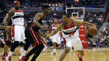 Apr 14, 2014; Washington, DC, USA; Washington Wizards guard Andre Miller (24) dribbles the ball as Miami Heat forward Udonis Haslem (40) defends in the second quarter at Verizon Center. Mandatory Credit: Geoff Burke-USA TODAY Sports