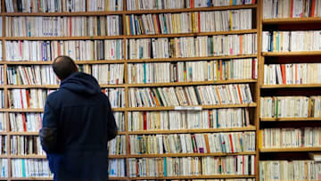 A man examines books in a bookshop on April 2, 2018 during a second-hand books fair in Becherel, western France. / AFP PHOTO / DAMIEN MEYER (Photo credit should read DAMIEN MEYER/AFP/Getty Images)
