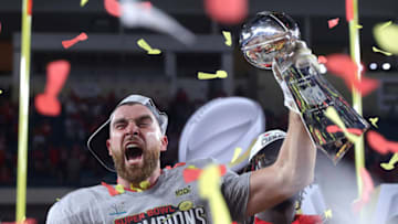 MIAMI, FLORIDA - FEBRUARY 02: Travis Kelce #87 of the Kansas City Chiefs raises the Vince Lombardi Trophy after defeating the San Francisco 49ers 31-20 in Super Bowl LIV at Hard Rock Stadium on February 02, 2020 in Miami, Florida. (Photo by Tom Pennington/Getty Images)