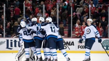 Feb 14, 2015; Detroit, MI, USA; Winnipeg Jets players celebrate their win over the Detroit Red Wings in a 5-4 shootout at Joe Louis Arena. Mandatory Credit: Tim Fuller-USA TODAY Sports
