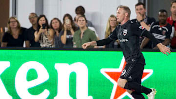 WASHINGTON, DC - JULY 14: D.C. United forward Wayne Rooney (9) dribbles past admiring fans during a MLS match between D.C. United and the Vancouver Whitecaps on July 14, 2018, at Audi Field, in Washington D.C.D.C United defeated the Vancouver Whitecaps 3-1.(Photo by Tony Quinn/Icon Sportswire via Getty Images)