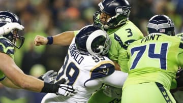 Dec 15, 2016; Seattle, WA, USA; Seattle Seahawks quarterback Russell Wilson (3) is hit by Los Angeles Rams defensive tackle Aaron Donald (99) after a pass attempt during the first quarter at CenturyLink Field. Mandatory Credit: Joe Nicholson-USA TODAY Sports