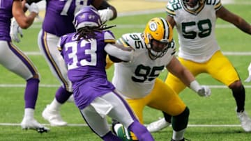 Green Bay Packers defensive tackle Tyler Lancaster (95) tries to tackle Minnesota Vikings running back Dalvin Cook (33) during their football game Sunday, September 13, 2020, at U.S. Bank Stadium in Minneapolis, Minn.Mjs Apc Lancaster 0913201131