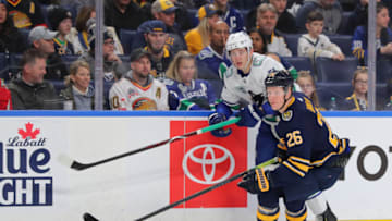 Jan 11, 2020; Buffalo, New York, USA; Vancouver Canucks defenseman Troy Stecher (51) makes a pass as Buffalo Sabres defenseman Rasmus Dahlin (26) watches the puck during the first period at KeyBank Center. Mandatory Credit: Timothy T. Ludwig-USA TODAY Sports
