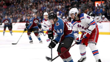 DENVER, COLORADO - JANUARY 04: Samuel Girard #49 of the Colorado Avalanche fights for the puck against Mika Zibanejad #92 of the New York Rangers in the third period at the Pepsi Center on January 04, 2019 in Denver, Colorado. (Photo by Matthew Stockman/Getty Images)