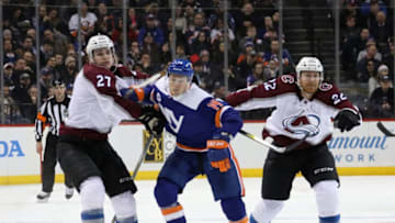 NEW YORK, NEW YORK - FEBRUARY 09: Tom Kuhnhackl #14 of the New York Islanders tries to get past Ryan Graves #27 and A.J. Greer #24 of the Colorado Avalanche during the second period at the Barclays Center on February 09, 2019 in the Brooklyn borough of New York City. (Photo by Bruce Bennett/Getty Images)