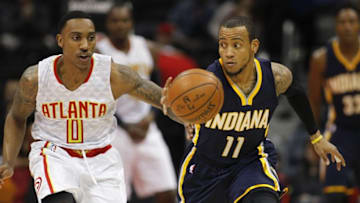 Feb 5, 2016; Atlanta, GA, USA; Atlanta Hawks guard Jeff Teague (0) and Indiana Pacers guard Monta Ellis (11) reach for a loose ball in the first quarter at Philips Arena. Mandatory Credit: Brett Davis-USA TODAY Sports