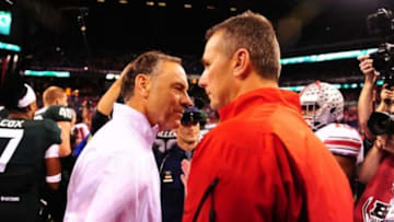 Dec 7, 2013; Indianapolis, IN, USA; Michigan State Spartans head coach Mark Dantonio shakes hands with Ohio State Buckeyes head coach Urban Meyer after being after the 2013 Big 10 Championship game at Lucas Oil Stadium. Michigan State Spartans derated Ohio State Buckeyes 34-24. Mandatory Credit: Andrew Weber-USA TODAY Sports