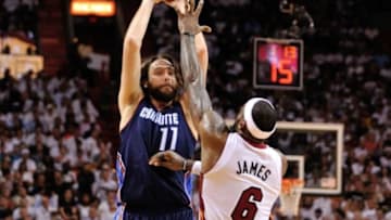 Apr 23, 2014; Miami, FL, USA; Charlotte Bobcats forward Josh McRoberts (11) shoots over Miami Heat forward LeBron James (6) in game two during the first round of the 2014 NBA Playoffs at American Airlines Arena. Mandatory Credit: Steve Mitchell-USA TODAY Sports
