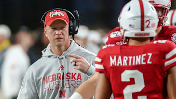 LINCOLN, NE - SEPTEMBER 28: Head coach Scott Frost of the Nebraska Cornhuskers talks with quarterback Adrian Martinez #2 during the game against the Ohio State Buckeyes at Memorial Stadium on September 28, 2019 in Lincoln, Nebraska. (Photo by Steven Branscombe/Getty Images)