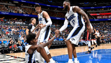 ORLANDO, FL - OCTOBER 7: Nikola Vucevic #9 and Jonathon Simmons #17 help up teammate Jonathan Isaac #1 of the Orlando Magic during a preseason against the Miami Heat game on October 8, 2017 at Amway Center in Orlando, Florida. NOTE TO USER: User expressly acknowledges and agrees that, by downloading and or using this photograph, User is consenting to the terms and conditions of the Getty Images License Agreement. Mandatory Copyright Notice: Copyright 2017 NBAE (Photo by Fernando Medina/NBAE via Getty Images)