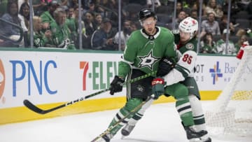 Sep 26, 2023; Dallas, Texas, USA; Dallas Stars defenseman Alexander Petrovic (28) and Minnesota Wild center Greg Meireles (85) in action during the game between the Dallas Stars and the Minnesota Wild at American Airlines Center. Mandatory Credit: Jerome Miron-USA TODAY Sports