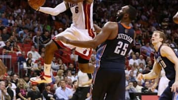 Mar 3, 2014; Miami, FL, USA; Miami Heat small forward LeBron James (6) drives to the basket past Charlotte Bobcats center Al Jefferson (25) in the second half at American Airlines Arena. Mandatory Credit: Robert Mayer-USA TODAY Sports