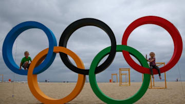 RIO DE JANEIRO, BRAZIL - JULY 21: Children pose with the Olympic Rings after its inauguration ceremony at the Copacabana Beach ahead 2016 Rio Olympics on July 21, 2016 in Rio de Janeiro, Brazil. (Photo by Buda Mendes/Getty Images)