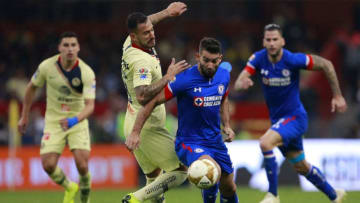 MEXICO CITY, MEXICO - DECEMBER 13: Victor Aguilera of America fights for the ball with Martin Cauteruccio of Cruz Azul during the final first leg match between America and Cruz Azul as part of the Torneo Apertura 2018 Liga MX at Azteca Stadium on December 13, 2018 in Mexico City, Mexico. (Photo by Mauricio Salas/Jam Media/Getty Images)
