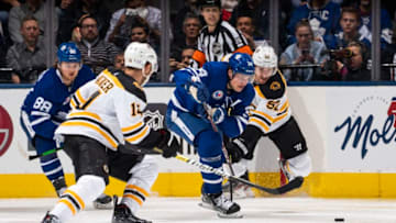 TORONTO, ON - NOVEMBER 15: Auston Matthews #34 of the Toronto Maple Leafs battles for the puck against Sean Kuraly #52 of the Boston Bruins during the second period at the Scotiabank Arena on November 15, 2019 in Toronto, Ontario, Canada. (Photo by Mark Blinch/NHLI via Getty Images)