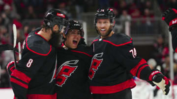 Oct 27, 2023; Raleigh, North Carolina, USA; Carolina Hurricanes left wing Teuvo Teravainen (86) celebrates his goal with defenseman Brent Burns (8) and defenseman Jaccob Slavin (74) against the San Jose Sharks during the third period at PNC Arena. Mandatory Credit: James Guillory-USA TODAY Sports