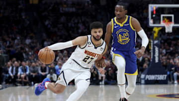 DENVER, COLORADO - FEBRUARY 02: Jamal Murray #27 of the Denver Nuggets drives against Jonathan Kuminga #00 of the Golden State Warriors in the first quarter at Ball Arena on February 2, 2023 in Denver, Colorado. NOTE TO USER: User expressly acknowledges and agrees that, by downloading and/or using this photograph, User is consenting to the terms and conditions of the Getty Images License Agreement. (Photo by Matthew Stockman/Getty Images)