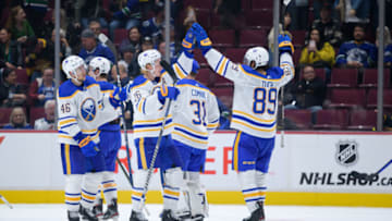 VANCOUVER, CANADA - OCTOBER 22: Rasmus Dahlin #26 and Alex Tuch #89 of the Buffalo Sabres celebrate after defeating the Vancouver Canucks after their NHL game at Rogers Arena October 22, 2022 in Vancouver, British Columbia, Canada. Buffalo won 5-1. (Photo by Derek Cain/Getty Images)