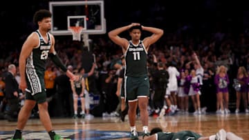 NEW YORK, NEW YORK - MARCH 23: Malik Hall #25, A.J. Hoggard #11 and Tyson Walker #2 of the Michigan State Spartans react after being defeated by the Kansas State Wildcats in overtime in the Sweet 16 round game of the NCAA Men's Basketball Tournament at Madison Square Garden on March 23, 2023 in New York City. (Photo by Elsa/Getty Images)