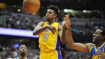 October 22, 2015; Anaheim, CA, USA; Los Angeles Lakers forward Nick Young (0) passes the ball against the defense of Golden State Warriors forward Harrison Barnes (40) and guard Andre Iguodala (9) during the second half at Honda Center. Mandatory Credit: Gary A. Vasquez-USA TODAY Sports