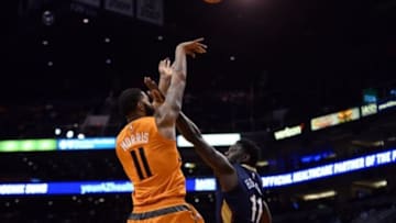 Dec 18, 2015; Phoenix, AZ, USA; Phoenix Suns forward Markieff Morris (11) shoots over New Orleans Pelicans guard Jrue Holiday (11) during the second half at Talking Stick Resort Arena. The Suns won 104-88. Mandatory Credit: Joe Camporeale-USA TODAY Sports