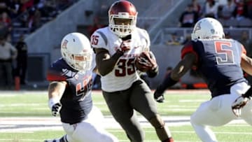 Nov 16, 2013; Tucson, AZ, USA; Washington State Cougars running back Marcus Mason (35) runs the ball under pressure from Arizona Wildcats linebacker Derrick Turituri (45) and cornerback Shaquille Richardson (5) during the fourth quarter at Arizona Stadium. The Cougars beat the Wildcats 24-17. Mandatory Credit: Casey Sapio-USA TODAY Sports
