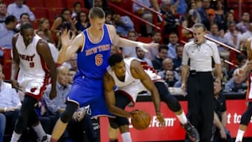 Nov 23, 2015; Miami, FL, USA; Miami Heat center Hassan Whiteside (21) controls the basket ball away from New York Knicks forward Kristaps Porzingis (6) during the first half at American Airlines Arena. Mandatory Credit: Steve Mitchell-USA TODAY Sports