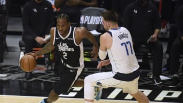 LOS ANGELES, CALIFORNIA - MAY 22: Kawhi Leonard #2 of the LA Clippers drives around Luka Doncic #77 of the Dallas Mavericks in the first quarter during game one of the Western Conference first round series at Staples Center on May 22, 2021 in Los Angeles, California. NOTE TO USER: User expressly acknowledges and agrees that, by downloading and or using this photograph, User is consenting to the terms and conditions of the Getty Images License Agreement. (Photo by Harry How/Getty Images)