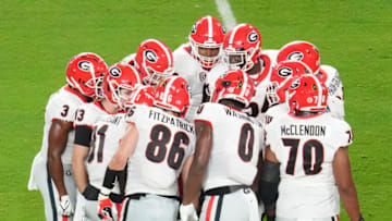 MIAMI GARDENS, FLORIDA - DECEMBER 31: Georgia Bulldogs huddle during the game against the Michigan Wolverines during the first half in the Capital One Orange Bowl for the College Football Playoff semifinal game at Hard Rock Stadium on December 31, 2021 in Miami Gardens, Florida. (Photo by Mark Brown/Getty Images)