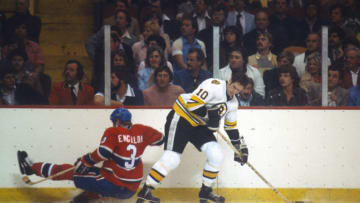 BOSTON, MA - CIRCA 1978: Jean Ratelle #10 of the Boston Bruins skates battles for control of the puck with Brian Engblom #3 of the Montreal Canadiens during an NHL Hockey game circa 1978 at the Boston Garden in Boston, Massachusetts. Ratelle's playing career went from 1960-81. (Photo by Focus on Sport/Getty Images)