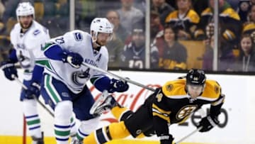 Jan 21, 2016; Boston, MA, USA; Vancouver Canucks left wing Daniel Sedin (22) dumps Boston Bruins right wing Brett Connolly (14) during the third period of the Vancouver Canucks 4-2 win over the Boston Bruins at TD Garden. Mandatory Credit: Winslow Townson-USA TODAY Sports