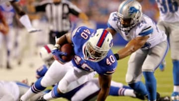 Aug 29, 2013; Orchard Park, NY, USA; Buffalo Bills running back Drew Smith (40) gets tackled by Detroit Lions safety Tyrell Johnson (24) during the second half at Ralph Wilson Stadium. The Lions won 35-13. Mandatory Credit: Timothy T. Ludwig-USA TODAY Sports