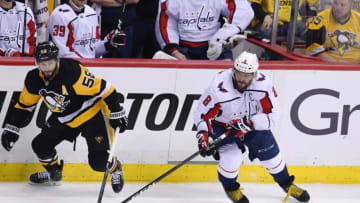 PITTSBURGH, PA - MAY 07: Pittsburgh Penguins defenseman Kris Letang (58) and Washington Capitals Left Wing Alex Ovechkin (8) go for the puck during the second period. The Washington Capitals went on win 2-1 in the overtime period against the Pittsburgh Penguins in Game Six of the Eastern Conference Second Round during the 2018 NHL Stanley Cup Playoffs on May 7, 2018, at PPG Paints Arena in Pittsburgh, PA. The Capitals won the series 4-2 and advance to the Eastern Conference Final. (Photo by Jeanine Leech/Icon Sportswire via Getty Images)