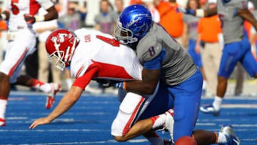 Oct.13, 2012; Boise,ID, USA; Fresno State Bulldogs quarterback Derek Carr (4) fumbles the ball after being tackled Boise State Broncos defensive lineman Demarcus Lawrence (8) during second half action at Bronco Stadium. Boise State defeated Fresno State 20-10. Mandatory Credit: Brian Losness-USA TODAY Sports