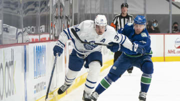 VANCOUVER, BC - APRIL 18: Auston Matthews #34 of the Toronto Maple Leafs tries to break free from the check of Tanner Pearson #70 of the Vancouver Canucks during NHL hockey action at Rogers Arena on April 17, 2021 in Vancouver, Canada. (Photo by Rich Lam/Getty Images)