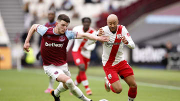 LONDON, ENGLAND - MAY 23: Declan Rice of West Ham United holds off Nathan Redmond of Southampton during the Premier League match between West Ham United and Southampton at London Stadium on May 23, 2021 in London, England. A limited number of fans will be allowed into Premier League stadiums as Coronavirus restrictions begin to ease in the UK. (Photo by John Sibley - Pool/Getty Images)