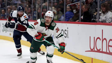 DENVER, COLORADO - DECEMBER 27: Mats Zuccarello #36 of the Minnesota Wild brings the puck off the boards against Ian Cole #28 of the Colorado Avalanche in the first period at the Pepsi Center on December 27, 2019 in Denver, Colorado. (Photo by Matthew Stockman/Getty Images)