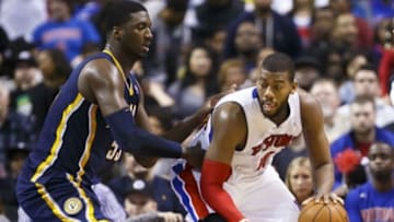 Mar 15, 2014; Auburn Hills, MI, USA; Detroit Pistons forward Greg Monroe (10) is defended by Indiana Pacers center Roy Hibbert (55) in the fourth quarter at The Palace of Auburn Hills. Indiana won in overtime 112-104. Mandatory Credit: Rick Osentoski-USA TODAY Sports
