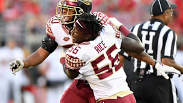 Sep 29, 2018; Louisville, KY, USA; Florida State Seminoles linebacker Emmett Rice (56) celebrates with Florida State Seminoles defensive back Jaiden Woodbey (20) after a play against the Louisville Cardinals during second half at Cardinal Stadium. Florida State defeated Louisville 28-24. Mandatory Credit: Jamie Rhodes-USA TODAY Sports