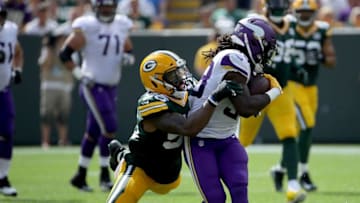GREEN BAY, WI - SEPTEMBER 16: Dalvin Cook #33 of the Minnesota Vikings is tackled by Korey Toomer #56 of the Green Bay Packers during the second quarter of a game at Lambeau Field on September 16, 2018 in Green Bay, Wisconsin. (Photo by Jonathan Daniel/Getty Images)