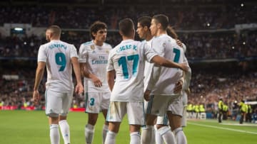 MADRID, SPAIN - NOVEMBER 25: Cristiano Ronaldo (right) of Real Madrid CF celebrates with teammates after scoring his team's 3rd goal from a penalty rebound during the La Liga match between Real Madrid and Malaga at Estadio Santiago Bernabeu on November 25, 2017 in Madrid, Spain. (Photo by Denis Doyle/Getty Images)