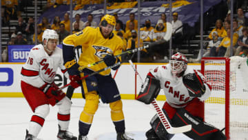 Yakov Trenin #13 of the Nashville Predators tries to deflect a puck in front of goalie Alex Nedeljkovic #39 of the Carolina Hurricanes during the first period in Game Six of the First Round of the 2021 Stanley Cup Playoffs at Bridgestone Arena on May 27, 2021 in Nashville, Tennessee. (Photo by Frederick Breedon/Getty Images)
