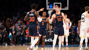 NEW YORK, NY - FEBRUARY 11: Julius Randle #30, Immanuel Quickley #5, and Isaiah Hartenstein #55 of the New York Knicks high five during the fourth quarter against the Utah Jazz at Madison Square Garden on February 11, 2023 in New York City. NOTE TO USER: User expressly acknowledges and agrees that, by downloading and or using this photograph, User is consenting to the terms and conditions of the Getty Images License Agreement. (Photo by Evan Yu/Getty Images)