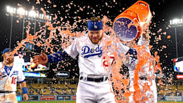 LOS ANGELES, CA - MAY 29: Joc Pederson #31 pours a cooler of sports drink on Alex Verdugo #27 after he his a sacrifice fly to score Cody Bellinger #35 of the Los Angeles Dodgers to defeat the New York Mets 9-8 in the ninth inning at Dodger Stadium on May 29, 2019 in Los Angeles, California. (Photo by Jayne Kamin-Oncea/Getty Images)