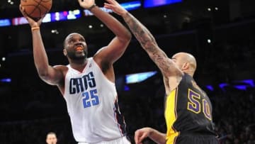 January 31, 2014; Los Angeles, CA, USA; Charlotte Bobcats center Al Jefferson (25) moves to the basket against the defense of Los Angeles Lakers center Robert Sacre (50) during the first half at Staples Center. Mandatory Credit: Gary A. Vasquez-USA TODAY Sports