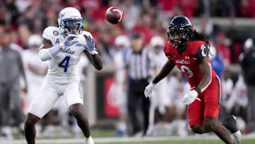 Tulsa receiver Josh Johnson catches a pass as Cincinnati cornerback Arquon Bush defends him. The Oklahoman.